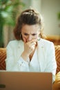 Shocked trendy woman with laptop at modern home in sunny day Royalty Free Stock Photo