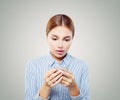 Shocked woman on cellphone. Girl texting on smartphone Royalty Free Stock Photo