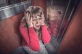 Shocked woman with claustrophobia in the moving elevator