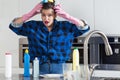 Shocked woman cleaning kitchen