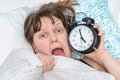 Shocked woman comes late to work because she oversleep