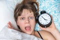 Shocked woman comes late to work because she oversleep