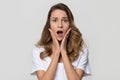 Shocked woman feeling terrified looking at camera on white background Royalty Free Stock Photo