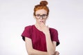 Shocked woman in glasses looking at camera with open mouth and touching head Royalty Free Stock Photo