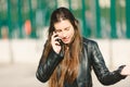 Shocked woman hearing good news over phone, female amazed by funny message received talking on cell, happy girl feeling can not Royalty Free Stock Photo