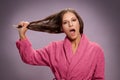 Shocked woman holding her dry damaged hair Royalty Free Stock Photo