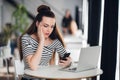 Shocked woman holding and looking sadly at mobile phone, she is disappointed and puzzled with received message. Royalty Free Stock Photo