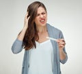 Shocked woman holding pregnant test and touchung her head. Royalty Free Stock Photo