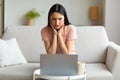Shocked Woman At Laptop Having Bad Internet Connection At Home