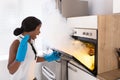 Shocked Woman Looking At Burnt Cookies In Oven