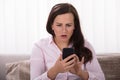 Shocked Woman Looking At Mobile Phone Royalty Free Stock Photo