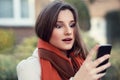 Shocked woman looking at mobile phone Royalty Free Stock Photo