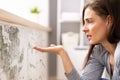 Shocked Woman Looking At Mold On Wall Royalty Free Stock Photo