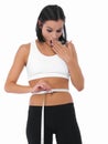 Shocked woman, tape measure and weight loss of waist for slim body or diet on a white studio background. Surprised