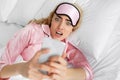 Shocked woman wakes up with anxiety, bad news and oversleep