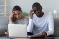 Shocked worried young mixed race family couple calculate bills Royalty Free Stock Photo