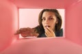 Shocked and xcited young girl looking inside carton box. Looking interested Royalty Free Stock Photo