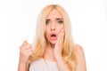 Shocked young blonde holding her damaged hair Royalty Free Stock Photo