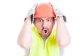 Shocked young builder holding his head looking desperate Royalty Free Stock Photo