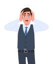 Shocked young businessman holding head with both hands. Frustrated person with scared expression. Headache pain or stress. Royalty Free Stock Photo