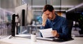 Shocked Young Businessman Reading Document At Desk Royalty Free Stock Photo