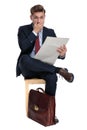 Shocked young businessman sitting on wooden chair Royalty Free Stock Photo