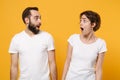 Shocked young couple friends bearded guy girl in white blank empty t-shirts posing isolated on yellow orange background Royalty Free Stock Photo