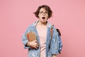 Shocked young girl student in denim clothes glasses backpack isolated on pastel pink background. Education in high Royalty Free Stock Photo