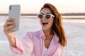 Shocked young girl in sunglasses taking a selfie by phone Royalty Free Stock Photo