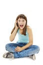 Shocked young girl talking on the phone