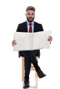 Shocked young guy in suit reading newspaper Royalty Free Stock Photo