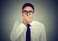 Shocked young man covering his mouth with hand Royalty Free Stock Photo