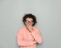 shocked young man with curly hair covering mouth with hand Royalty Free Stock Photo