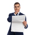 Shocked young man in elegant suit reading newspaper Royalty Free Stock Photo