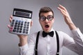 Shocked Young Man Holding Calculator Royalty Free Stock Photo
