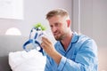 Shocked Young Man Holding CPAP Machine Royalty Free Stock Photo