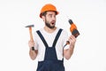 Shocked young man holding drill and hammer Royalty Free Stock Photo