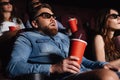 Shocked young man sitting in cinema watch film Royalty Free Stock Photo