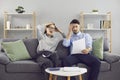 Shocked young married couple looking at notice of bankruptcy or high utility bills Royalty Free Stock Photo