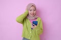 Shocked Young Muslim woman looking at her phone, surprised get good news Royalty Free Stock Photo