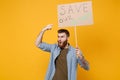 Shocked young protesting man pointing index finger on protest sign broadsheet placard on stick isolated on yellow