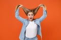 Shocked young woman girl in casual denim clothes posing isolated on bright orange wall background studio portrait Royalty Free Stock Photo