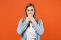 Shocked young woman girl in casual denim clothes posing isolated on orange wall background studio portrait. People Royalty Free Stock Photo