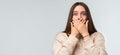 Shocked young woman covering mouth with hands on white background. Keep silence concept. Copy space Royalty Free Stock Photo