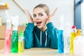 shocked young woman looking at camera while sitting at table with plastic bottles Royalty Free Stock Photo