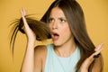 Shocked young woman looking at her hair Royalty Free Stock Photo