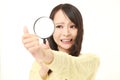 Shocked young woman looking through a magnifying glass her nails Royalty Free Stock Photo