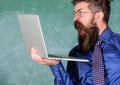 Shocking information. Hipster teacher wear eyeglasses and necktie holds laptop surfing internet. Teacher bearded shocked