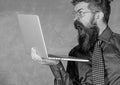 Shocking information. Hipster teacher wear eyeglasses and necktie holds laptop surfing internet. Teacher bearded shocked