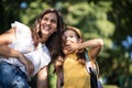 Little girl and her mother holding hands and walking trough nature. Little girl carrying school bag on back Royalty Free Stock Photo